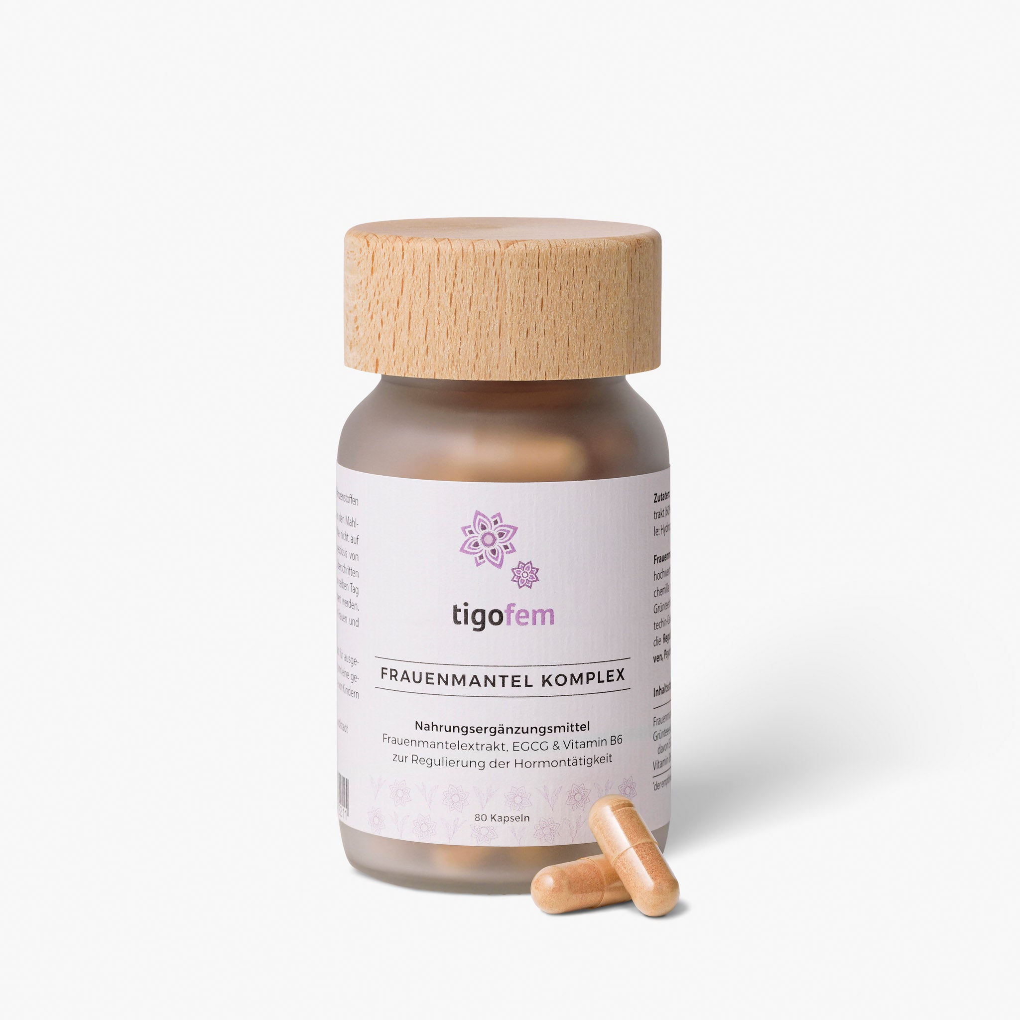 tigofem Frauenmantel Komplex Kapseln mit Vitamin B6 im Glasflakon mit Holzverschluss und zwei Kapseln im Vordergrund.