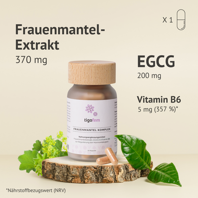 tigofem Frauenmantel-Extrakt Kapseln mit EGCG & Vitamin B6 – 80 Stück Glasdose auf Holzscheibe mit Blättern.